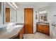 Well-lit bathroom with dual vanities, granite countertops, and tile floors at 4014 S Kirk Way, Aurora, CO 80013