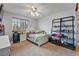 Bedroom featuring a white bedframe, shelving, window, and carpeted floors at 4014 S Kirk Way, Aurora, CO 80013
