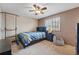 Bedroom with ceiling fan, window with blinds, a bed, and dark furniture at 4014 S Kirk Way, Aurora, CO 80013