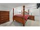 Bedroom featuring a wooden four-poster bed, dresser, and side tables with lamps at 4014 S Kirk Way, Aurora, CO 80013