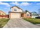 Inviting two-story home with a two-car garage and spacious driveway, set against a sunny sky at 4014 S Kirk Way, Aurora, CO 80013