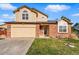 Charming two-story home with a well-maintained lawn and attached two-car garage at 4014 S Kirk Way, Aurora, CO 80013