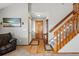 Inviting foyer features wood floors, a staircase, and a charming coat rack at 4014 S Kirk Way, Aurora, CO 80013