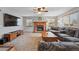 Cozy living room with a brick fireplace, large TV, and neutral color palette at 4014 S Kirk Way, Aurora, CO 80013
