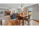 Open concept living area featuring a fireplace, wood floors, and a dining table with seating at 4014 S Kirk Way, Aurora, CO 80013