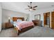 Primary bedroom featuring neutral walls, wood furniture, and a large closet at 4014 S Kirk Way, Aurora, CO 80013