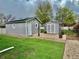 The backyard offers a shed with green roof, a greenhouse and large grassy area at 98 N 12Th Ave, Brighton, CO 80601