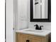 Bathroom vanity with a modern sink, dark fixtures and light wood cabinetry at 98 N 12Th Ave, Brighton, CO 80601