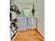 Bright laundry room features a new washer and dryer, wood flooring, and shelving for organized storage at 98 N 12Th Ave, Brighton, CO 80601
