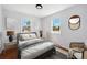 Main bedroom featuring hardwood floors, ample sunlight, and cozy decor at 98 N 12Th Ave, Brighton, CO 80601