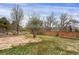 The backyard features a stone patio area, a garden area, a grass yard, and a privacy fence at 8441 Timberwood St, Littleton, CO 80126