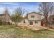 Backyard features a stone patio and well-maintained lawn, perfect for outdoor relaxation and entertaining at 8441 Timberwood St, Littleton, CO 80126
