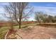 A backyard featuring a stone patio with a built-in wooden retaining wall at 8441 Timberwood St, Littleton, CO 80126