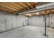 Unfinished basement with concrete walls and floors, exposed beams, and visible utilities at 8441 Timberwood St, Littleton, CO 80126