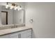 Bathroom featuring stylish vanity with a modern faucet, mirror and light fixture at 8441 Timberwood St, Littleton, CO 80126