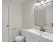 Bright bathroom features vanity, toilet and mirror at 8441 Timberwood St, Littleton, CO 80126