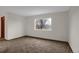 Bedroom featuring neutral walls and carpet with a large window showing mountain views at 8441 Timberwood St, Littleton, CO 80126