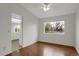 Cozy dining room boasts hardwood floors, a ceiling fan, neutral paint, and an open layout to the kitchen at 8441 Timberwood St, Littleton, CO 80126