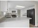 Bright kitchen features white cabinets, light countertop and stainless steel appliances at 8441 Timberwood St, Littleton, CO 80126