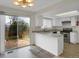 Bright kitchen features white cabinets, light countertop, stainless steel appliances and backyard access at 8441 Timberwood St, Littleton, CO 80126