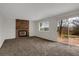 Living room features fireplace, plush carpet and backyard access at 8441 Timberwood St, Littleton, CO 80126