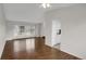 Bright living room features hardwood floors, large windows, and an open layout leading to the kitchen at 8441 Timberwood St, Littleton, CO 80126