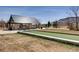 Community bocce ball court with lush green field and seating area, perfect for outdoor recreation and socializing at 6220 Salvia St, Arvada, CO 80403