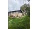 Well-maintained backyard with mature landscaping, lush green lawn, and charming brick home at 3000 Billings St, Aurora, CO 80011