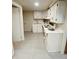 Basement kitchen features white cabinets, ample counter space, and a double sink at 3000 Billings St, Aurora, CO 80011