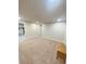Finished basement room features carpet, a finished wall, and access to additional rooms at 3000 Billings St, Aurora, CO 80011