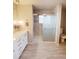 Bathroom featuring double sinks, granite countertop, and walk-in shower at 3000 Billings St, Aurora, CO 80011