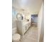 Bright bathroom featuring a double sink vanity, decorative mirrors, and modern lighting fixtures at 3000 Billings St, Aurora, CO 80011