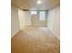 Bright bedroom with carpet, two windows, and closet space at 3000 Billings St, Aurora, CO 80011