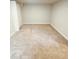 Large, neutral carpeted room with simple decor and natural light at 3000 Billings St, Aurora, CO 80011