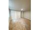 A neutral carpeted bedroom with dual closets and simple lighting at 3000 Billings St, Aurora, CO 80011