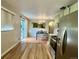 Bright kitchen with stainless steel appliances opens to the dining area with natural light at 3000 Billings St, Aurora, CO 80011