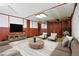 Living room features stylish seating, a center table, and a console with a large screen TV at 2813 S Zenobia St, Denver, CO 80236