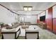 Living room in basement features contemporary furniture, a cozy rug, and a large TV for entertainment at 2813 S Zenobia St, Denver, CO 80236