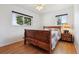 Relaxing bedroom with a wooden bed frame, ceiling fan, and hardwood floors at 2813 S Zenobia St, Denver, CO 80236