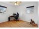 Bedroom with hardwood floors, two windows, a ceiling fan and desk at 2813 S Zenobia St, Denver, CO 80236