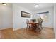 Bright dining area features wood floors, a large window, and a wooden table with chairs at 2813 S Zenobia St, Denver, CO 80236