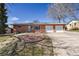 Charming brick home featuring a two-car garage, mature trees, and a landscaped front yard at 2813 S Zenobia St, Denver, CO 80236