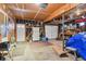 Spacious garage with ample storage, a workbench, and two access doors, one leading outside at 2813 S Zenobia St, Denver, CO 80236