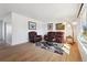 Bright living room with wood floors, a large window, and comfortable leather furniture at 2813 S Zenobia St, Denver, CO 80236