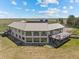 Aerial view of a large home featuring multiple decks, surrounded by a vast, grassy landscape and distant trees at 30999 Kootney St, Elizabeth, CO 80107
