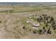 Aerial shot showcasing the property layout including buildings, trees, and the surrounding landscape at 30999 Kootney St, Elizabeth, CO 80107