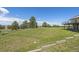 Expansive backyard with lush green grass, mature trees, and a view of the home's multiple decks at 30999 Kootney St, Elizabeth, CO 80107