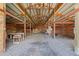 Interior view of a barn with wooden beams and a dirt floor, showing ample space at 30999 Kootney St, Elizabeth, CO 80107