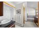 Bathroom includes a vanity and shower, with a view of a tub and bedroom at 30999 Kootney St, Elizabeth, CO 80107