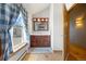 Bathroom featuring a wooden vanity, ample lighting, a window, and wooden floors at 30999 Kootney St, Elizabeth, CO 80107